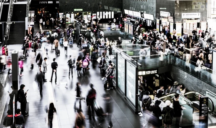 Passengers walking through a busy airport terminal