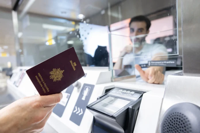 Passenger presenting a passport at border control at Brussels Airport